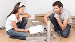 Man and woman building diy furniture